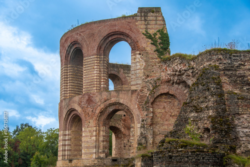 Roman ruins of the Imperial Baths with preserved brick arches and historic walls against a blue sky
