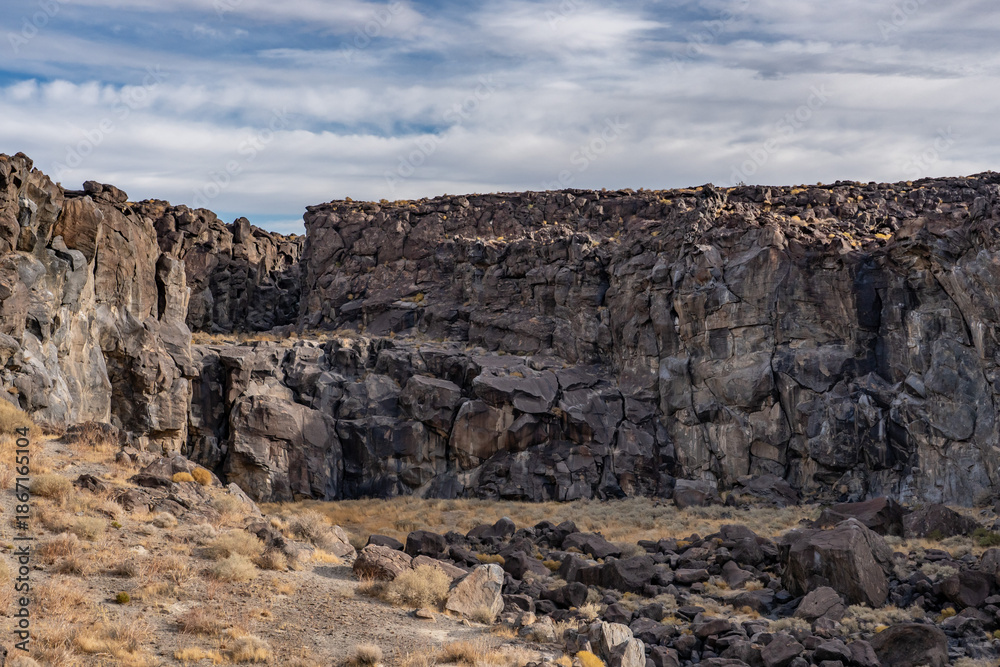 Fototapeta premium Volcanic rock, Basalt flows. Fossil Falls Trail, Coso Volcanic Field, Inyo County, California. Coso Range, Basin and Range Province.