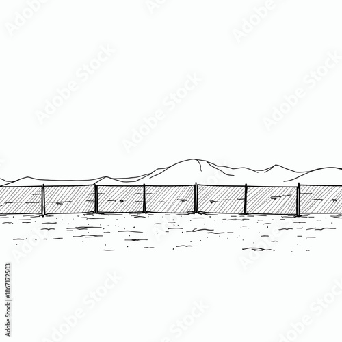 Simple fence set against mountainous landscape in black and white  