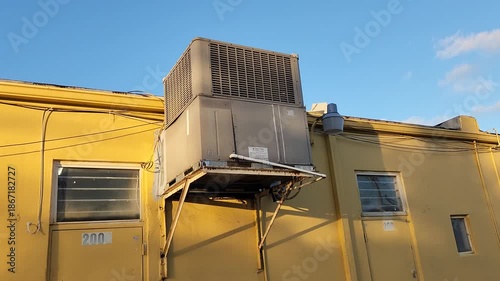 Damaged air conditioner external unit with visible water leakage