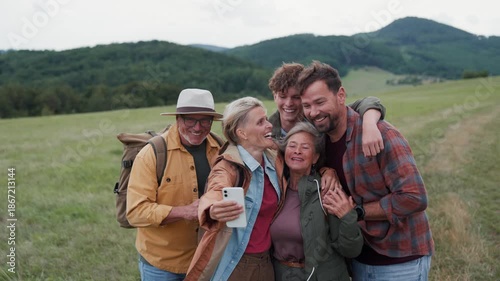 Family taking selfie on hiking trip in the nature.