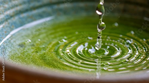 Ginger + Lemon Myrtle tea/Tencha/Japanese loose-leaf tea trickling in the tea bowl. Organic Beverage Industry, Functional Blends, Immunity Support concept. ar 16:9, slow motion video, close up.