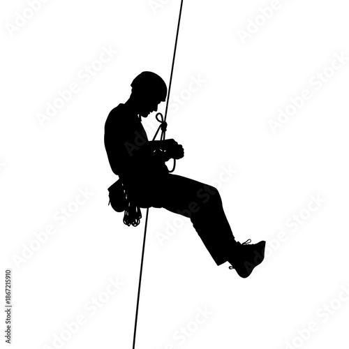 Silhouette of a man rappelling down a rope.