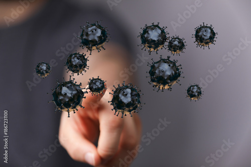 Photos Hand interacting with coronavirus cells