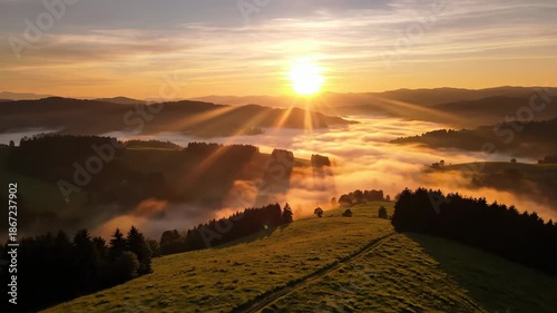 Sunrise over rolling hills with golden sunlight and morning mist
