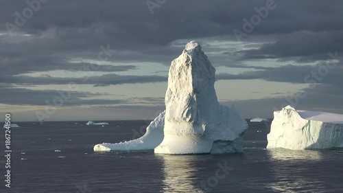 Iceberg formation observed in the ocean around Greenland on a clear day in summer