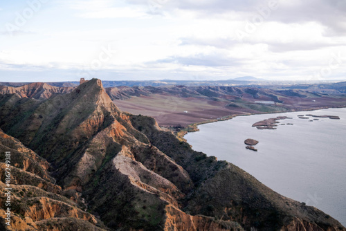 Hidden rocky cliffs Toledo Barrancas de Burujón reservoir panoramic landscape shadows sunlight