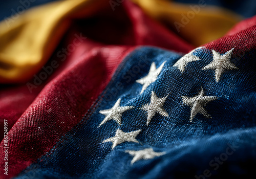 Detailed close-up of the Venezuelan flag with embroidered stars and fabric texture in dramatic lighting
