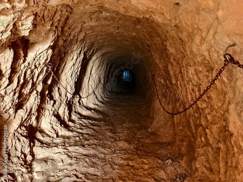 descending vertical shaft, process of moving downward through vertical shaft structure into lower