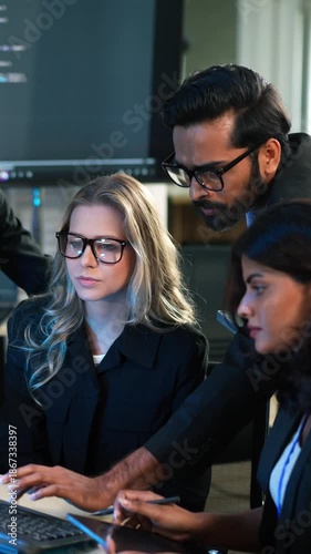 Indian IT manager checking and training work to software developers or business team at the office. Reviewing work on computer. Programming, and data security strategy at the meeting