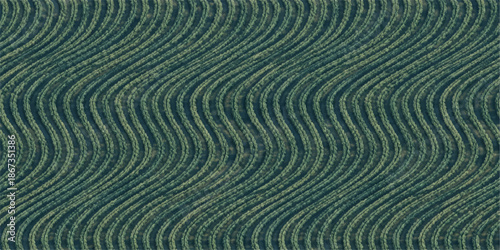 Abstract blue water ripples and sandy beach patterns merge in a natural landscape where summer sun creates textured waves across a brown desert dune background