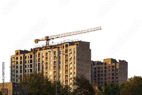 Cuadro en lienzo Under construction high multi-storey building with tower type construction crane isolated on transparent, white background