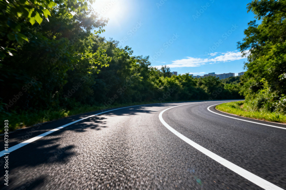 Fototapeta premium Scenic Curved Road Through Lush Green Forest