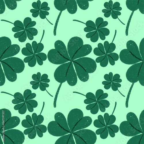 seamless pattern green shamrocks and four-leaf clovers on a light green background.