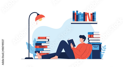 Relaxed man lying on the floor reading a book, surrounded by large stacks of books and a lamp for a cozy study time.