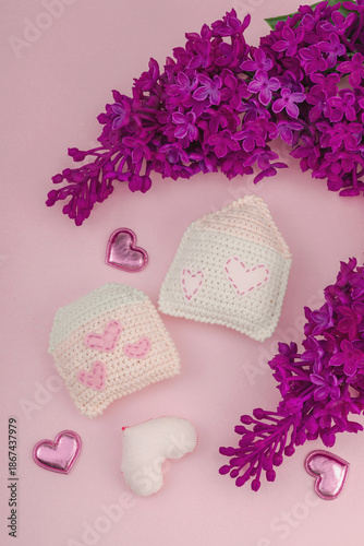 Handmade Valentines Day concept. Creative house figurines, traditional hearts, spring crocheting
