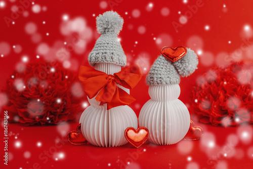 Snowmen couple in love with handmade felt heart. Festive greeting card concept, Valentine's Day