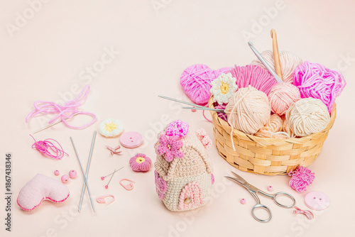 Handmade spring decor concept. Creative crocheting, house figurine, traditional flowers and hearts