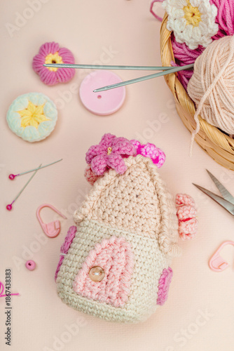 Handmade spring decor concept. Creative crocheting, house figurine, traditional flowers and hearts