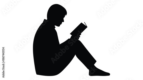 A silhouette of a person sitting and reading a book intently