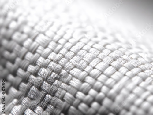 Macro texture of a white carbon fiber pattern showcasing a subtle weave, highlighting intricate details and smooth surface, ideal for design and automotive applications