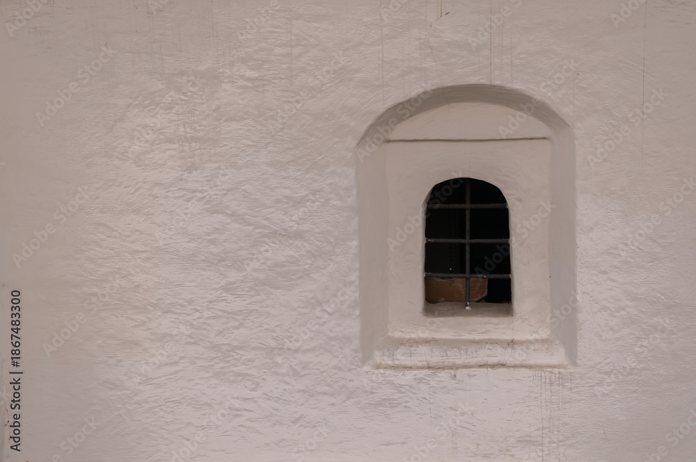 Fototapeta premium An arched window with a lattice in an Orthodox church
