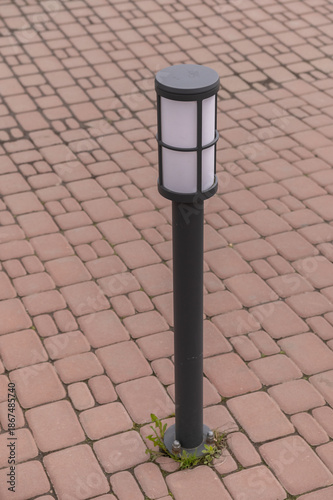 A street lamp among the paving slabs