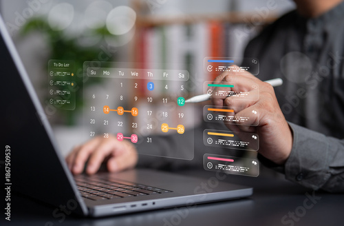 Person uses laptop and stylus to manage a glass effect style digital calendar and to-do list overlay. Ideal for futuristic business planning, time management, remote work, and digital productivity.