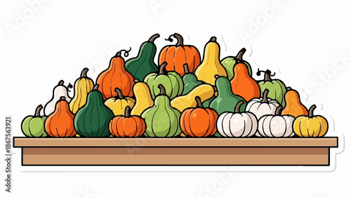 A colorful assortment of gourds and pumpkins piled high on a wooden surface