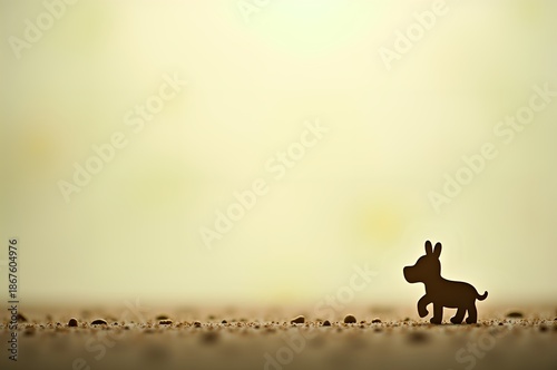 Silhouette of a Dog on Pebble Beach at Sunset