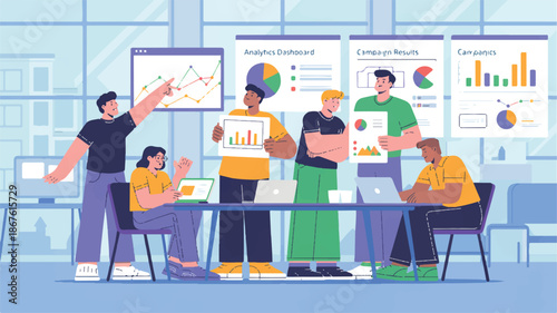 group of people working together at a table with laptops and charts on the wall