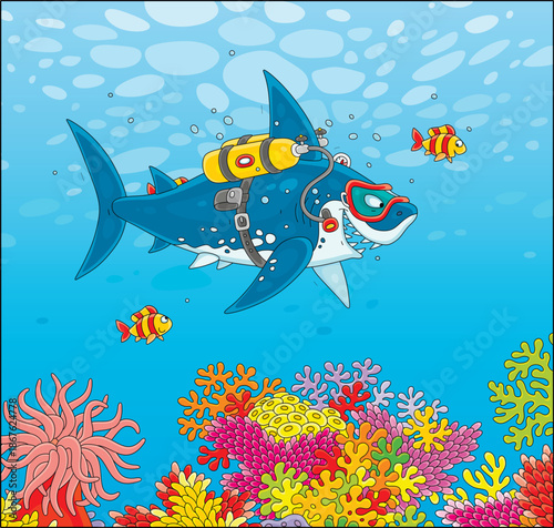 Funny great white shark scuba diver swimming with small striped fishes over a colorful coral reef in a tropical sea, vector cartoon illustration