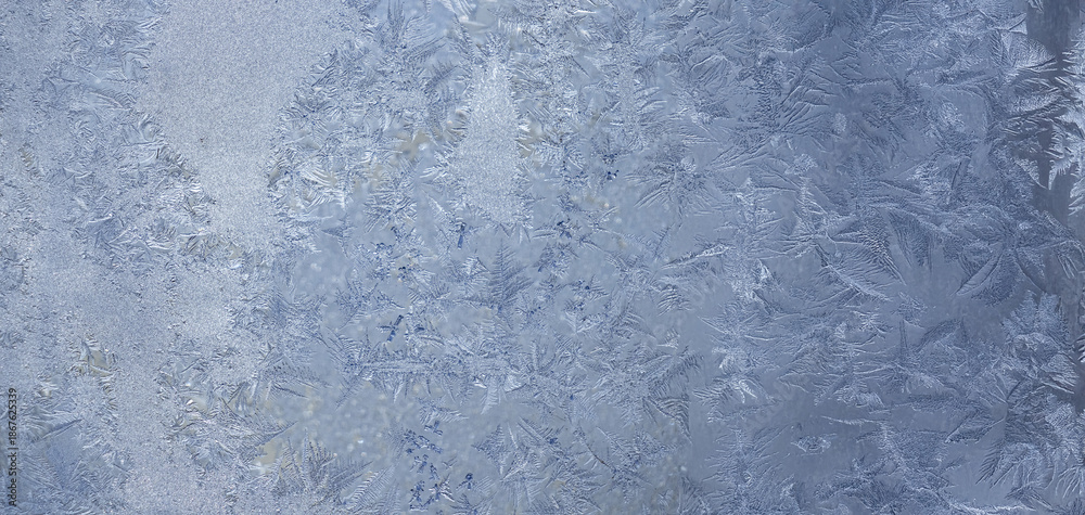 Fototapeta premium Ice crystals in the detail on a window glass in winter time