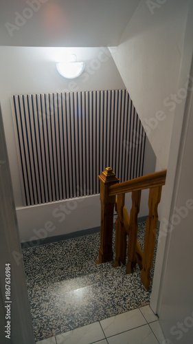 Granite staircase. Light on the staircase landing