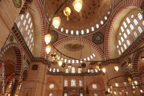 Interior of the Suleymaniye Mosque dome with hanging lamps
