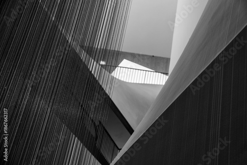 Abstract Monochrome Architectural Interior Featuring Textured Metal Curtains and Geometric Concrete Shapes