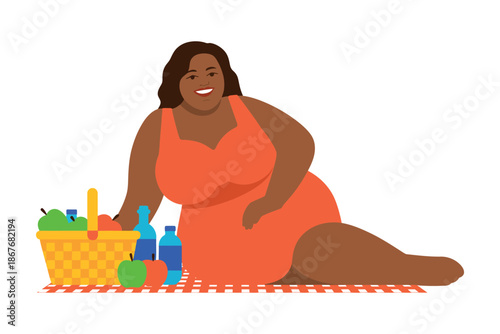 A plus-sized woman enjoys a picnic on a blanket with a basket of fresh fruit and bottles of water