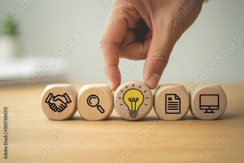 Design Thinking Process concept. Wooden blocks with icons; the key stages of the design thinking process, a solution-focused, problem-solving methodology used for innovation and strategic development.