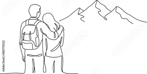 couple standing on mountain peak looking out at mountains