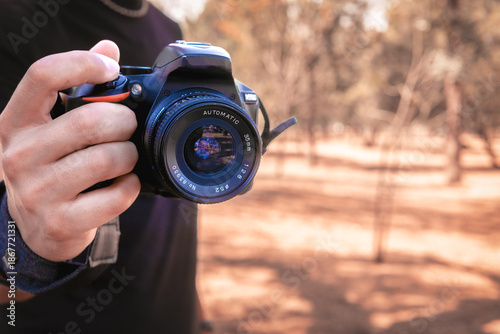 Latino man taking happy outdoor photos on a sunny day, perfect image to commemorate