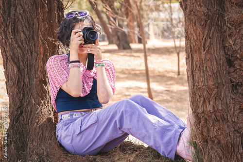 Latina teenager taking happy outdoor photos on a sunny day, perfect image to commemorate