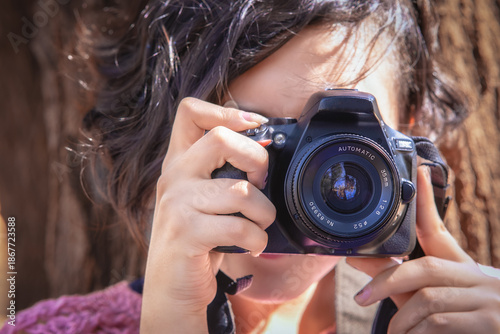 Latina teenager taking happy outdoor photos on a sunny day, perfect image to commemorate