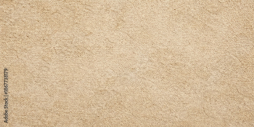 A vintage brown kraft paper texture featuring a rough, blank cardboard surface with a grunge antique pattern and beige parchment design for a textured old material backdrop