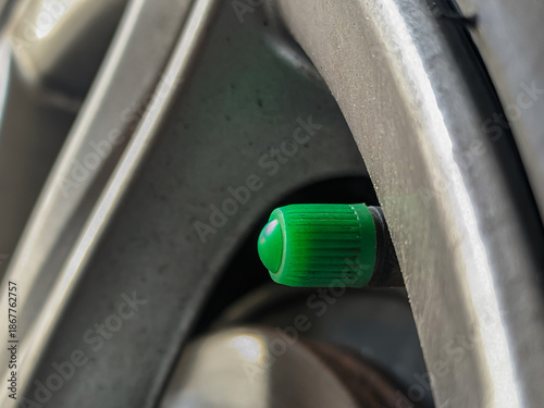 Fotografie Close up of a green car tire valve cap