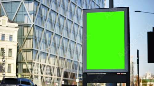 Urban street advertising billboard with blank green screen mockup for promotion