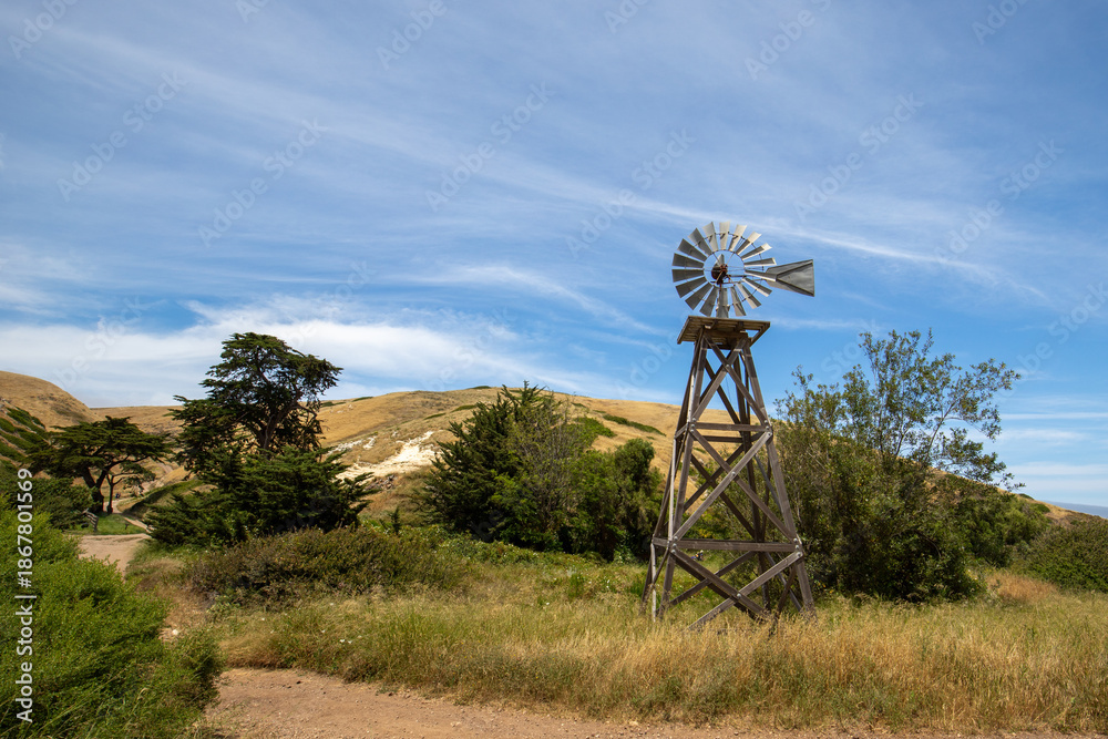 Fototapeta premium Public Ranch Windmill under blue cirrus sky in the Channel Islands National Park off the coast of Santa Barbara California USA