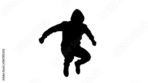 A silhouette of a person jumping in the air with arms outstretched and one leg bent