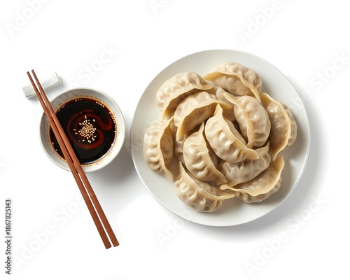 Top View of Steamed Chinese Dumplings or Jiaozi on Plate with Soy Sauce and Chopsticks. chopsticks and bowl