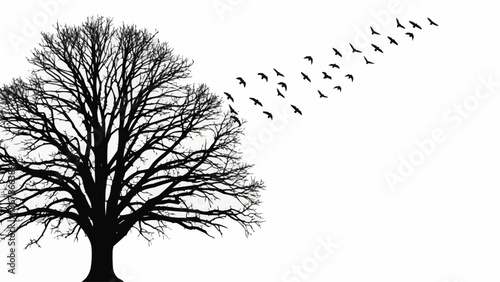 Silhouette of a bare tree with a flock of birds flying away.