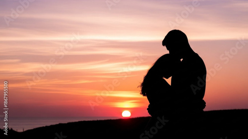 Silhouette of a man sitting on a hill at sunset contemplating life with a peaceful sky representing solitude and reflection